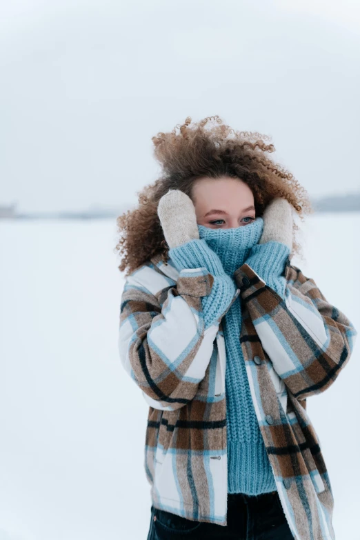 a woman with curly hair covering her face