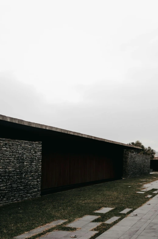 a long dark wall next to a road