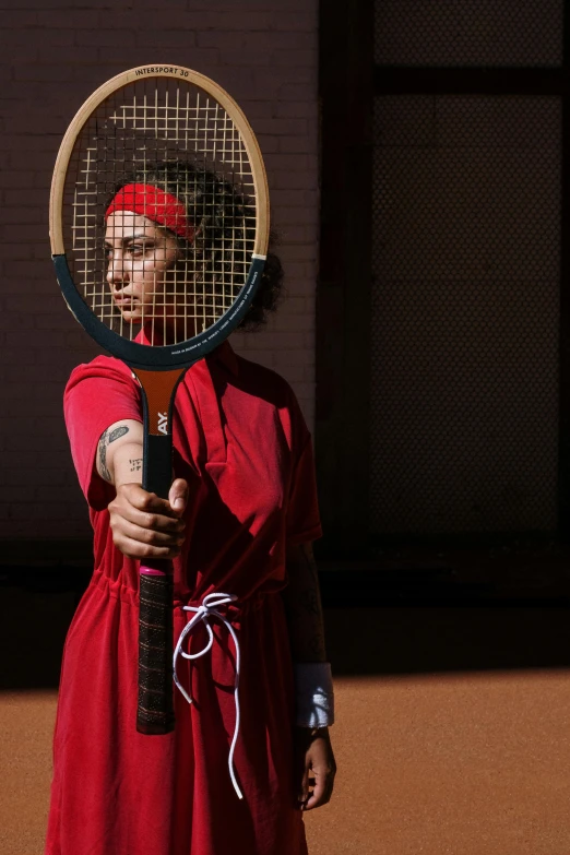 this tennis player is wearing red and holding his racquet