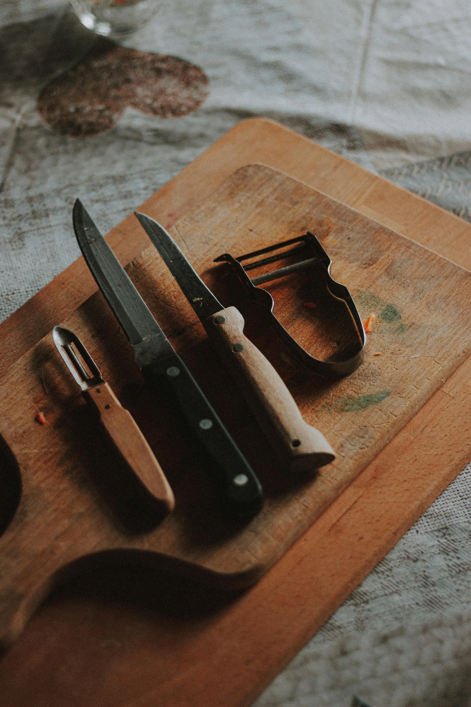 an antique knife and a pair of scissors are on a  board