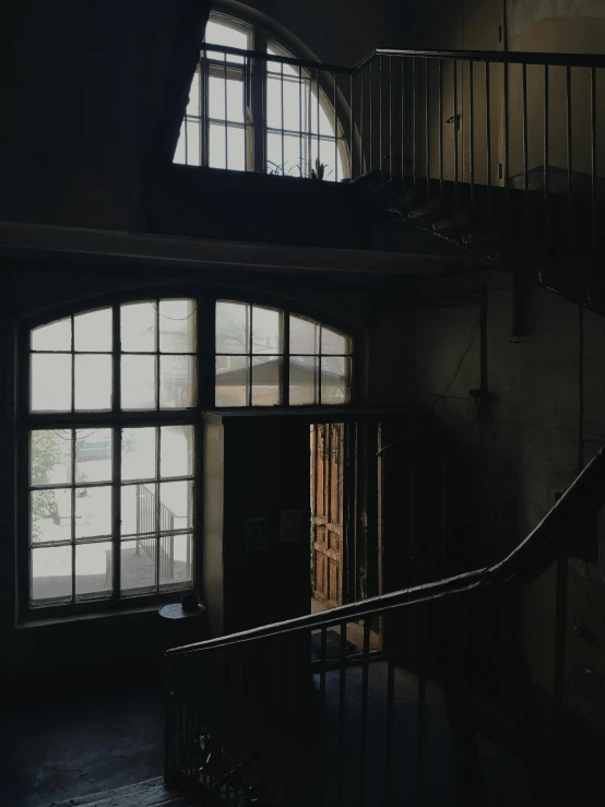 a staircase leading to several open windows in a building