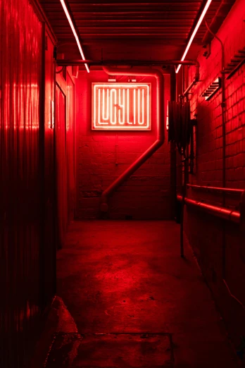 a dark tunnel with the neon sign glows red