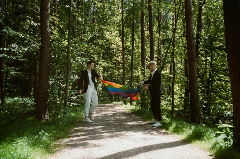 the two people are on the path in the woods