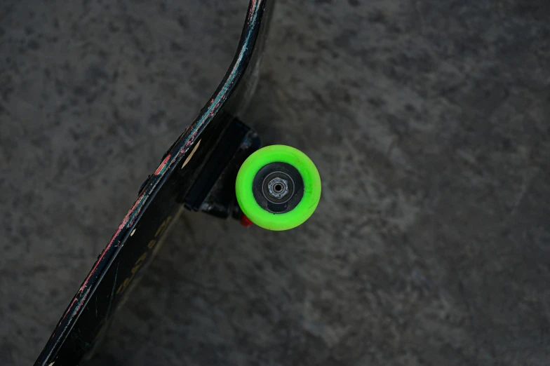 an overhead view of a skateboard with the bottom part of it neon green