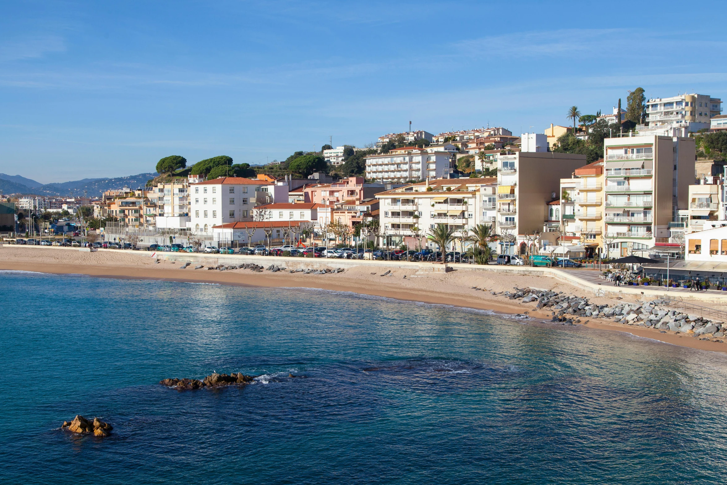 a city on the beach is seen from across the water