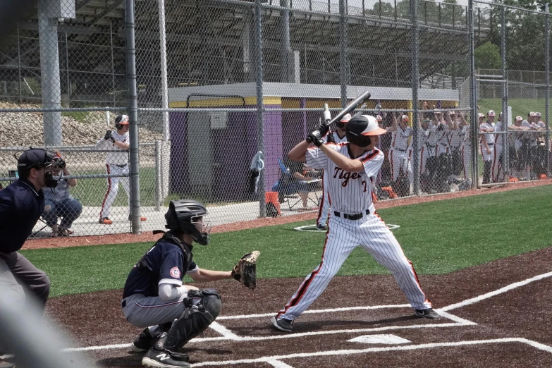 a baseball player holding a bat on top of a field