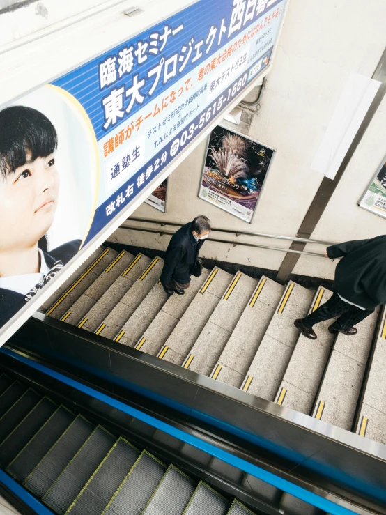 the boys are walking up and down the escalator in the mall