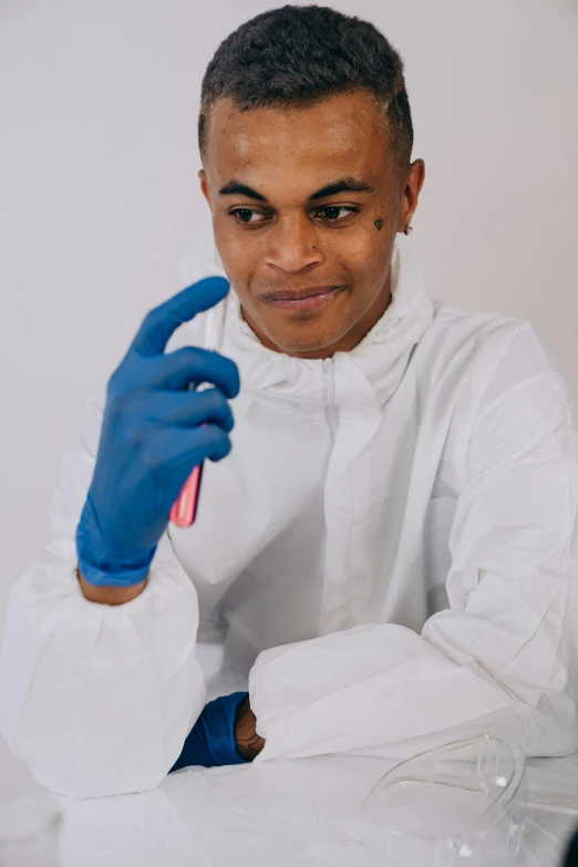 man wearing blue gloves making peace sign sign