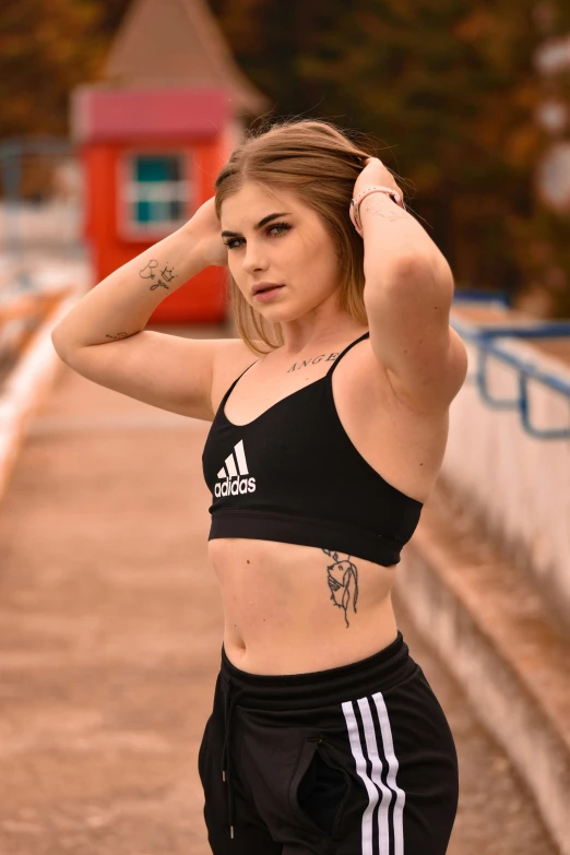 young woman in a black sports  top and sweat pants