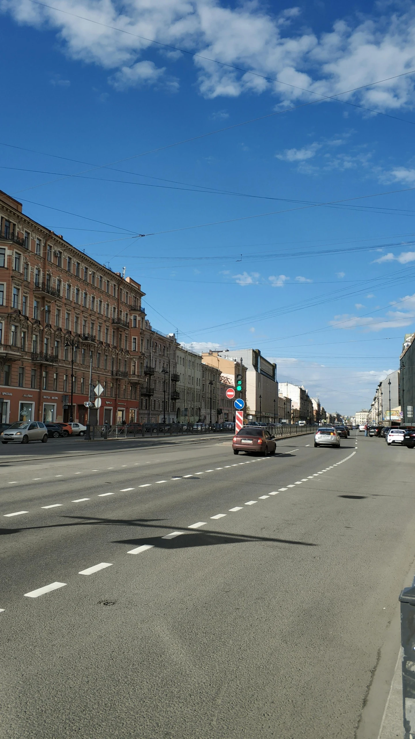 cars are parked along the curb in an otherwise empty road