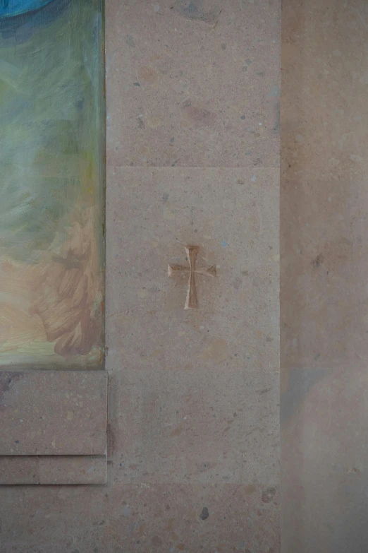 the cross is next to the wall in the corner of the room