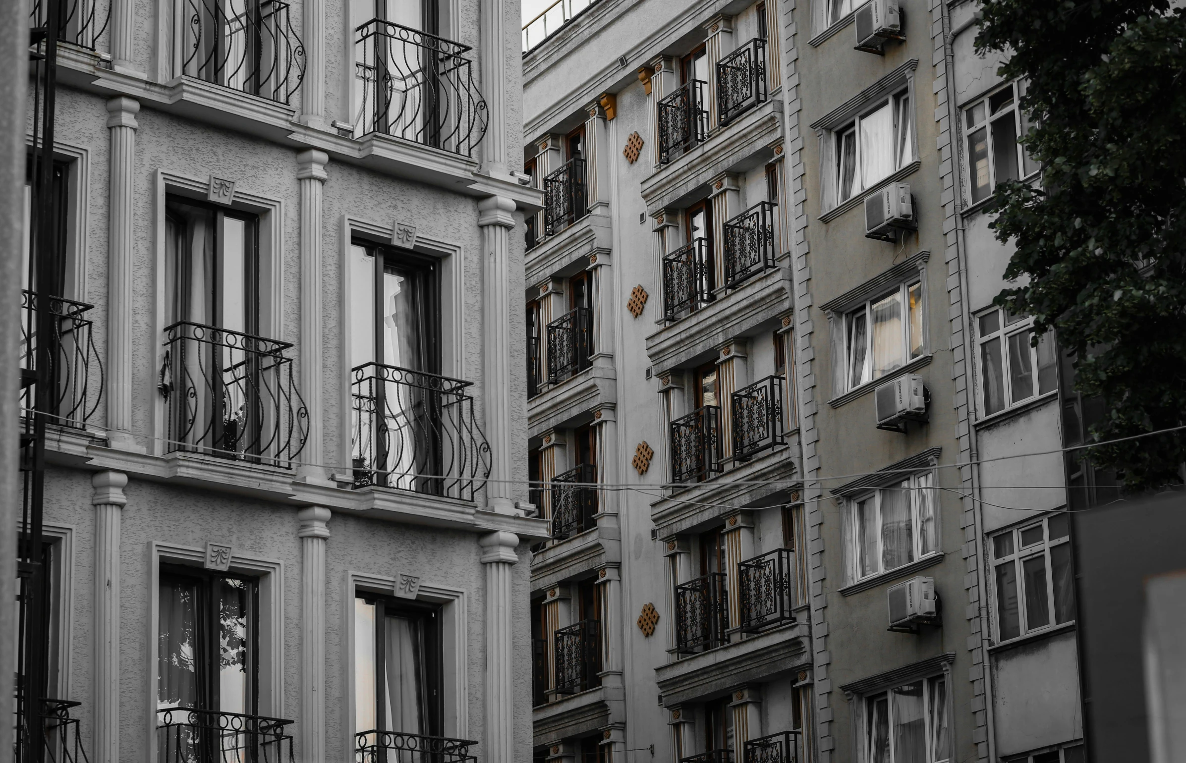 a group of buildings with balconies and bicycles parked in them