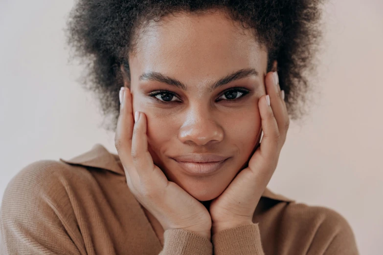 a woman is shown with her hand on her face