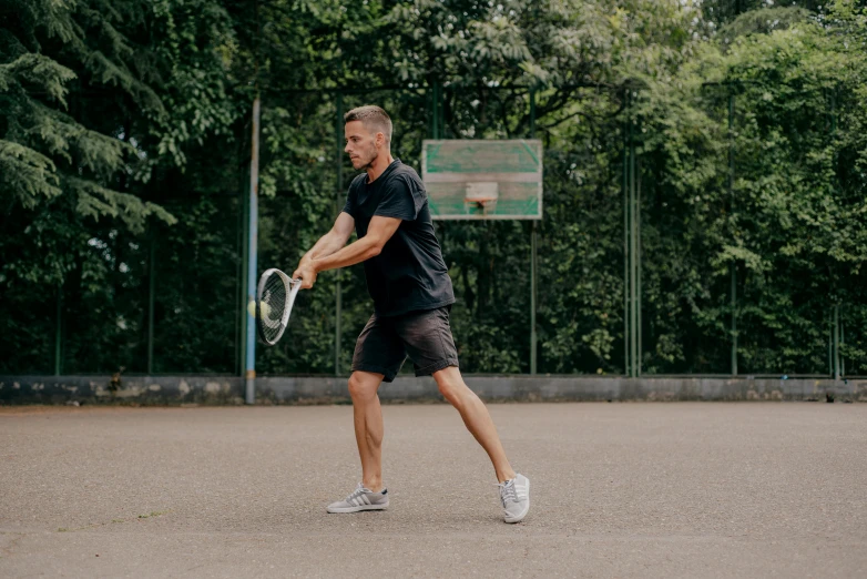 a man swings his tennis racket during a game