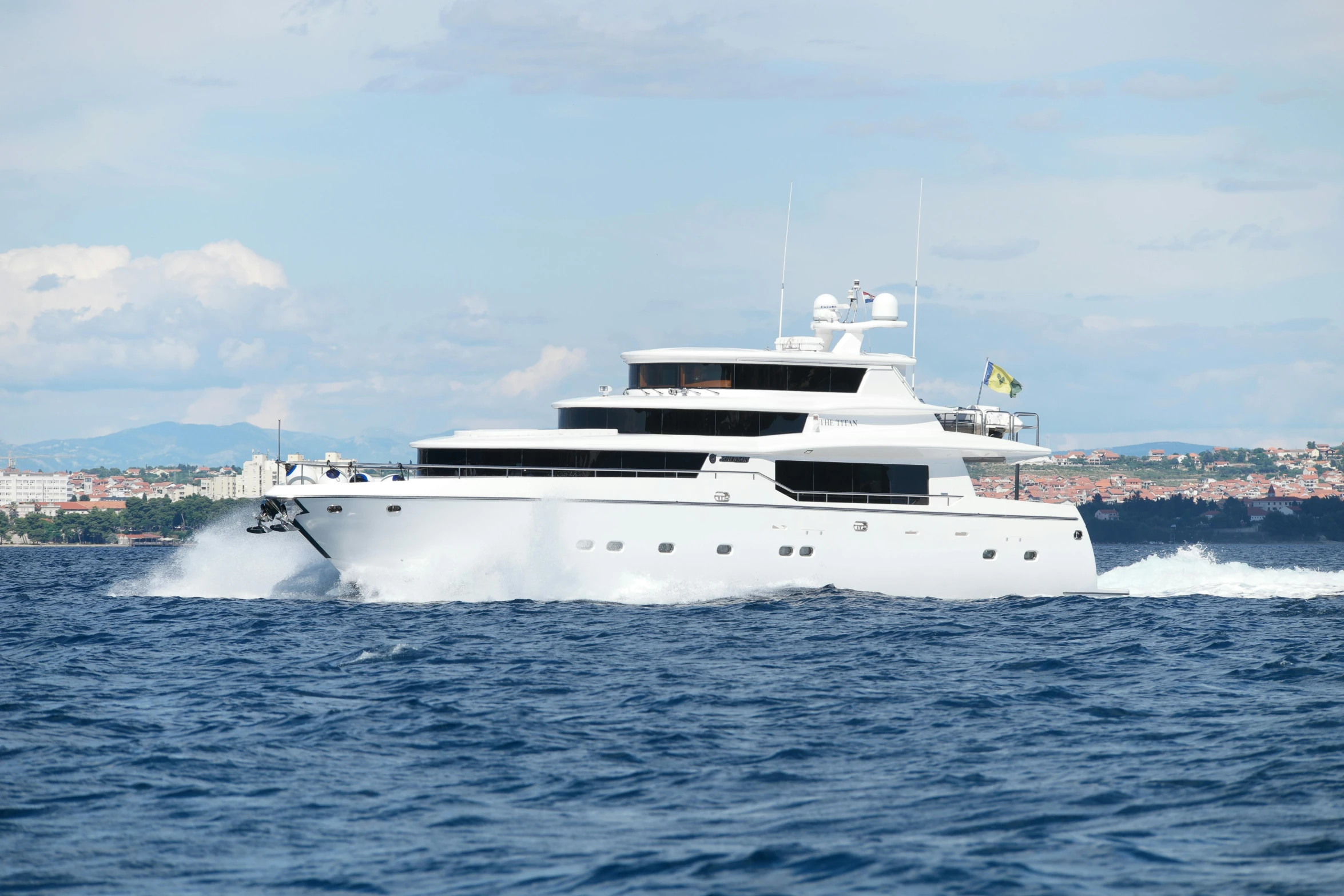 a large white yacht sailing across a large body of water