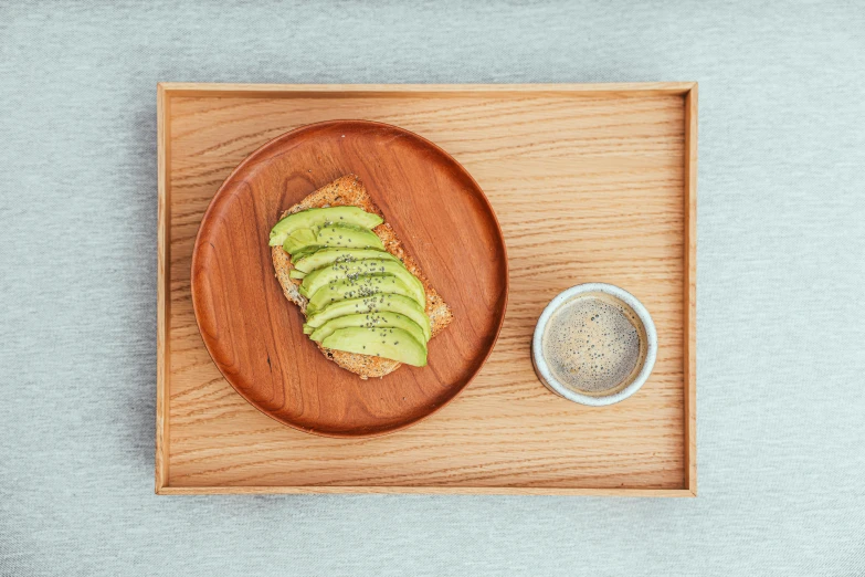 bread with avocado slices on it is on a plate