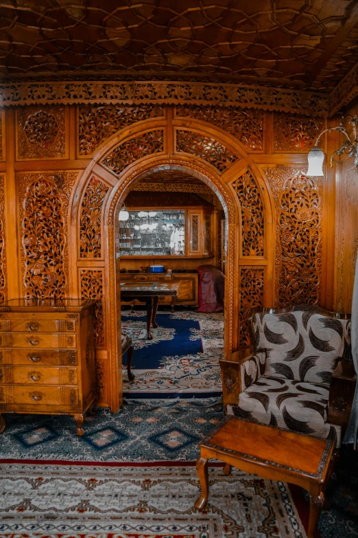 a wooden desk in a room with an archway