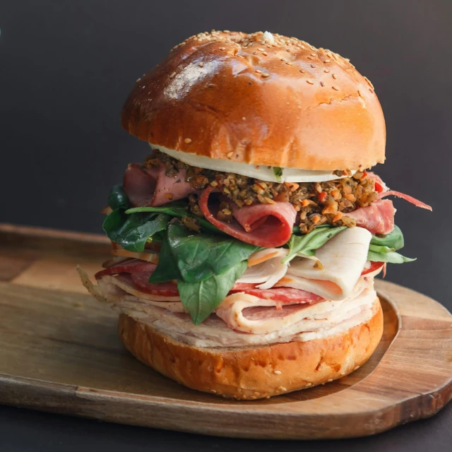 a sandwich that is sitting on a wooden plate