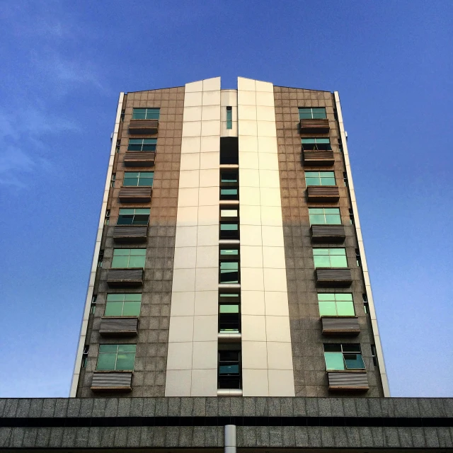 a tall building with windows and balconies on the side