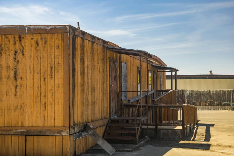 a small wooden shack with steps to it and a ladder to it