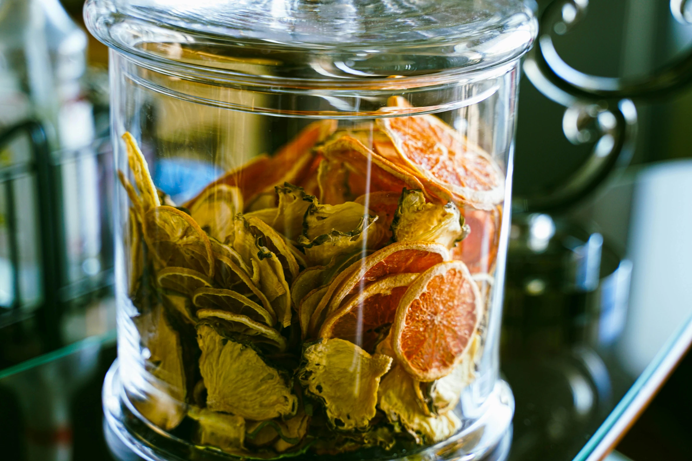 a jar filled with dried orange slices on top of a table