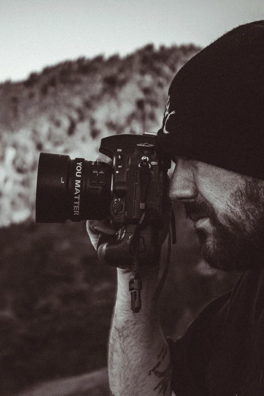 a man holding up his camera on a trip