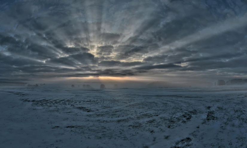 a very cold snowy field with a few tracks