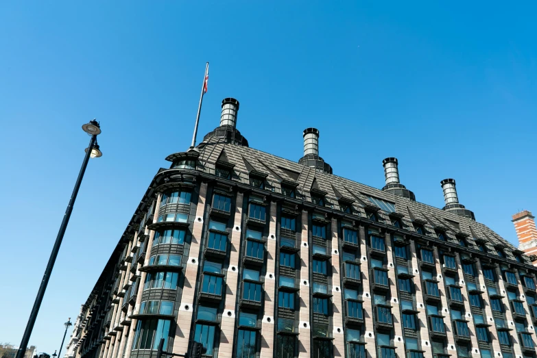 a tall building with a flag on top