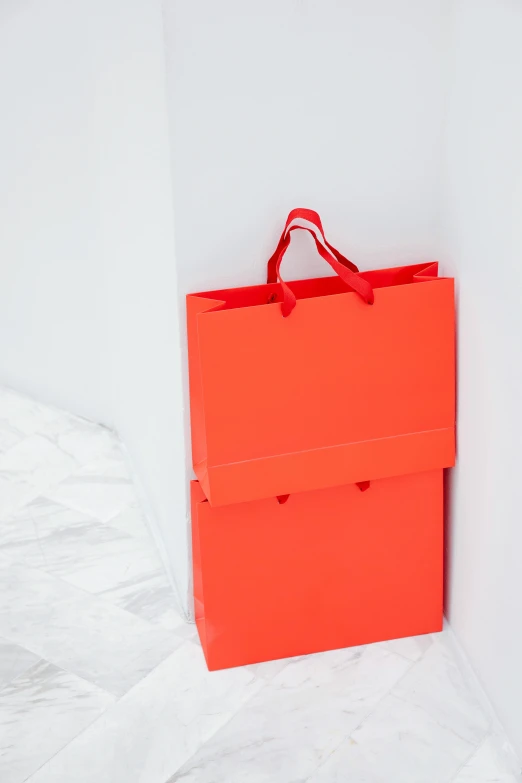 an orange shopping bag that is hanging up