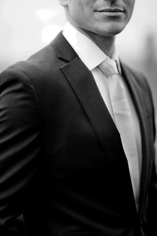 a black and white po of a man with a tie