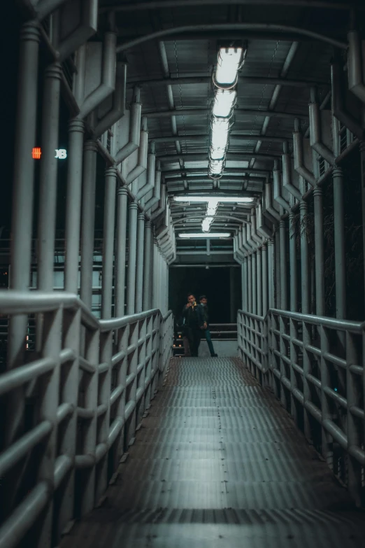 a couple walking through the night tunnel