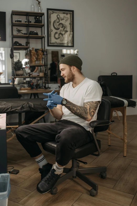 a man is getting his tattoos tattooed in a studio