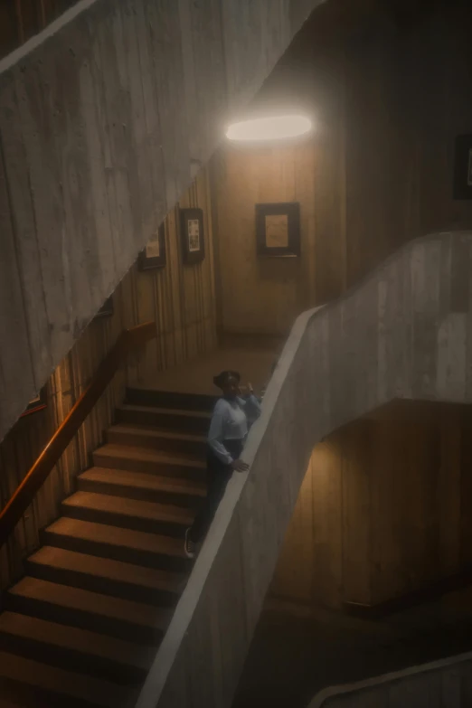a person standing at the bottom of stairs in a dimly lit room