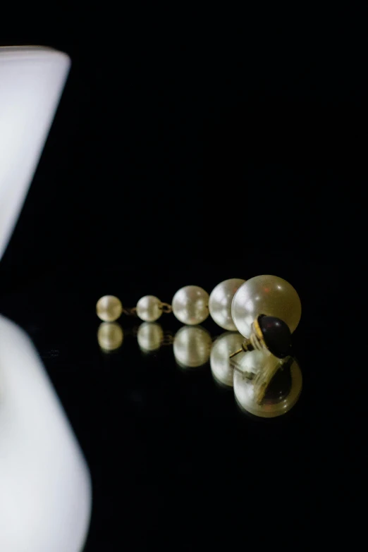 a table with three pearl necklaces and a celet