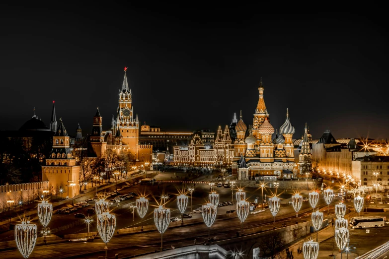 a town at night with lighted buildings and christmas decorations