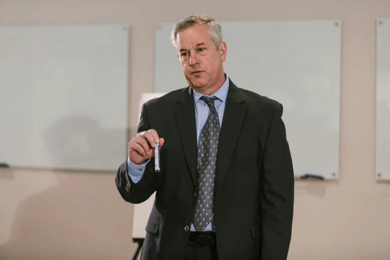 a man wearing a suit and tie while standing