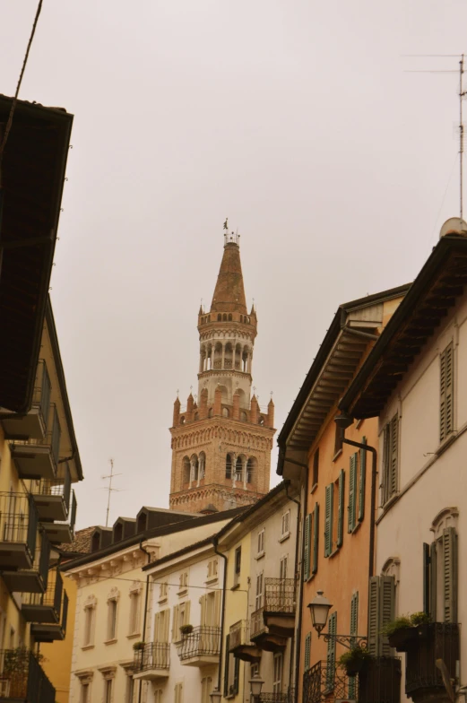 a tall clock tower towering over many small buildings