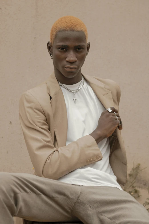 a man with blonde hair sitting on a bench