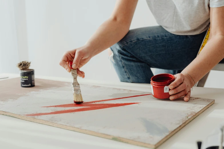 a woman is holding a brush while painting