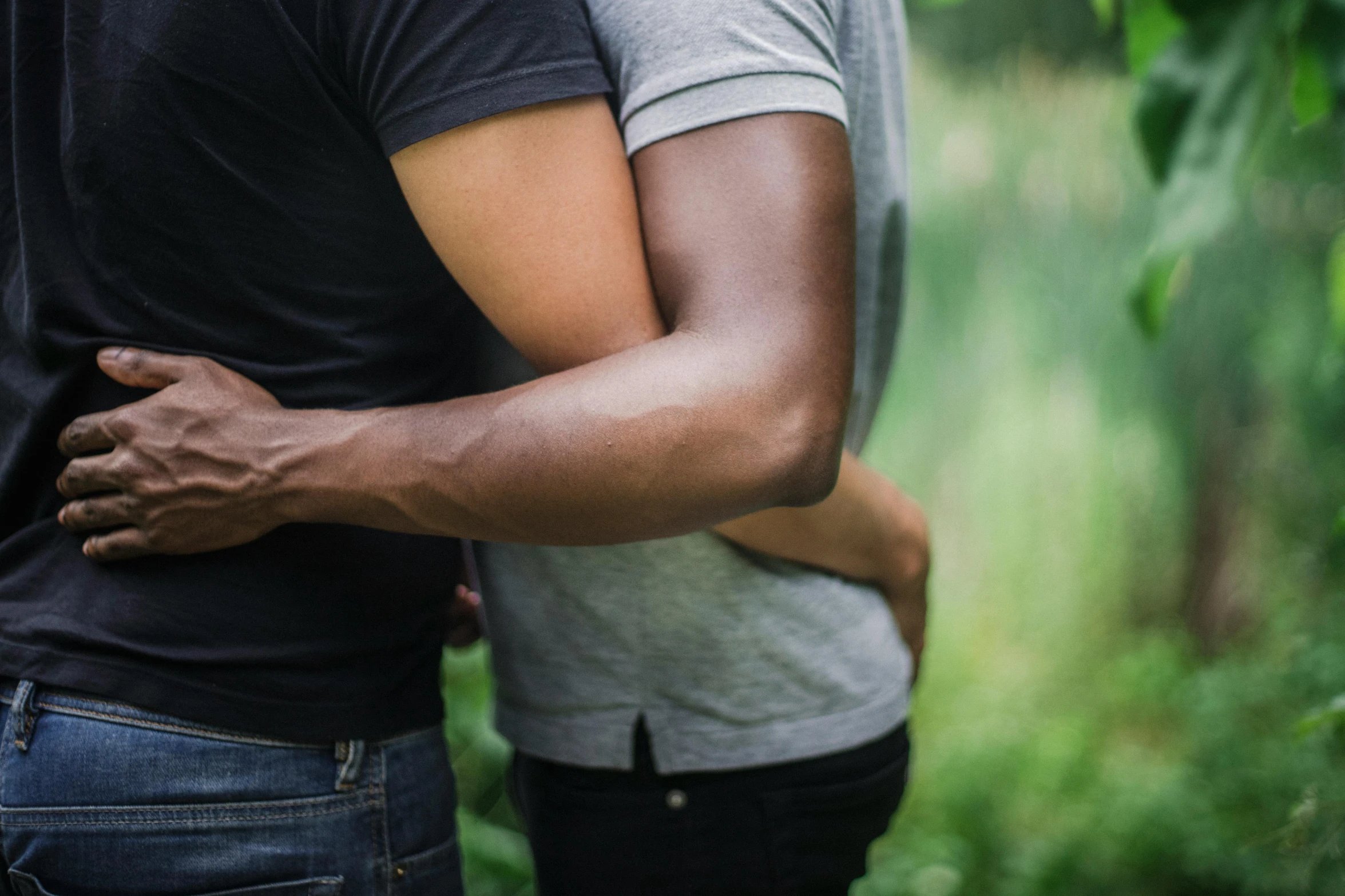 man and woman emcing each other in the woods