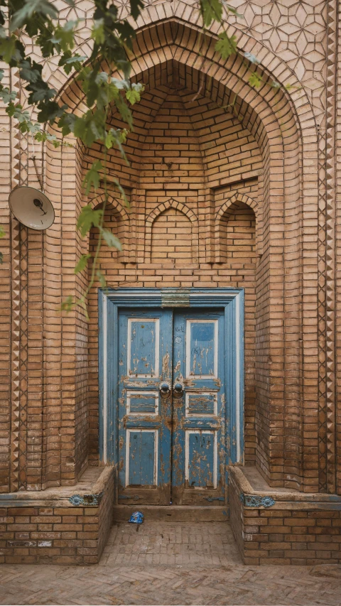 a wooden door with a blue brick design