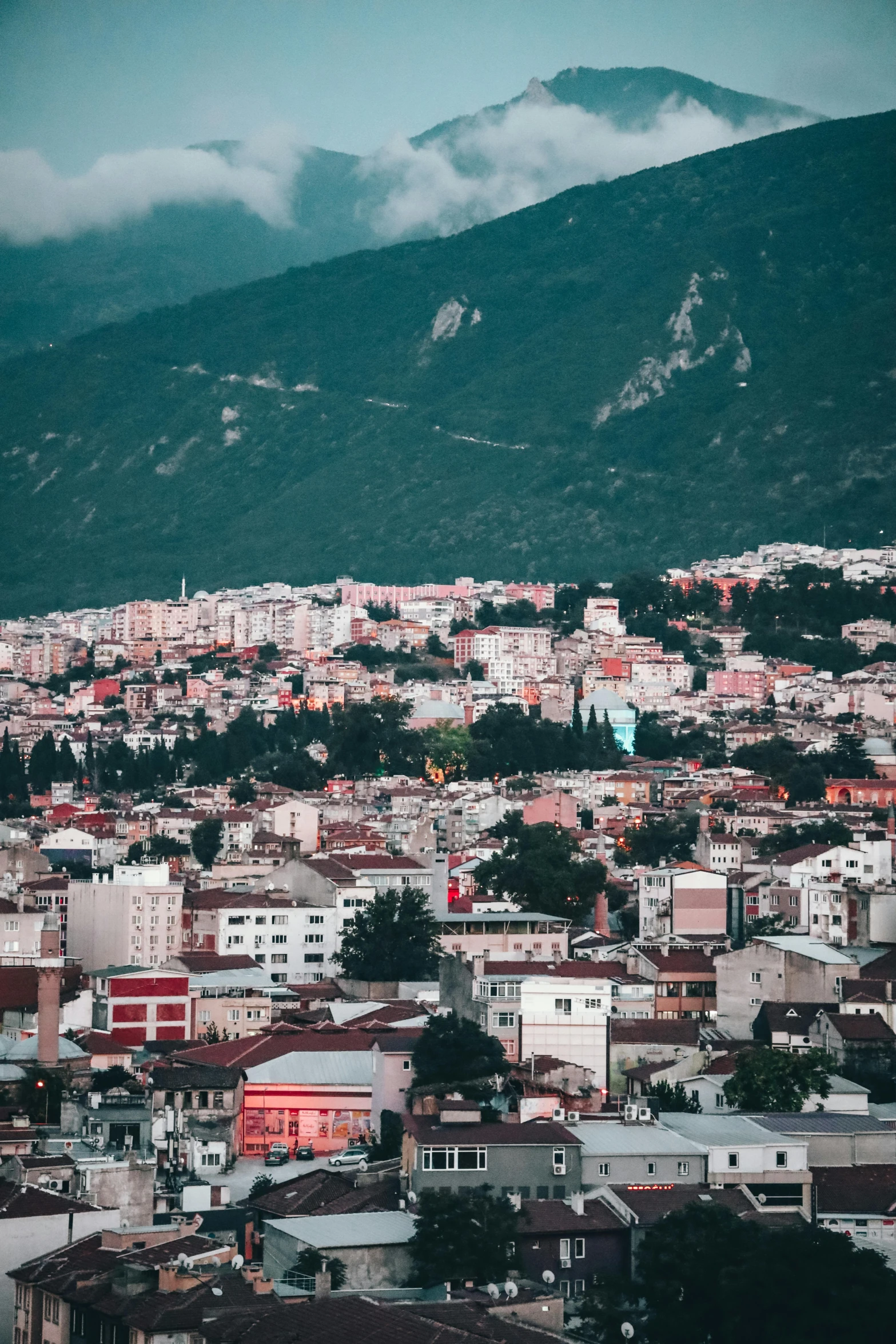 the view of a small town below the mountains