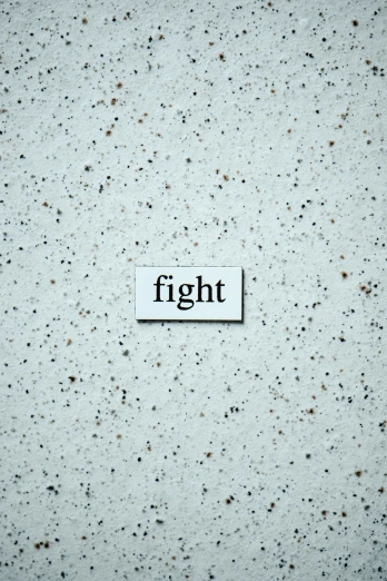 a dirty surface with an old sign saying, fight