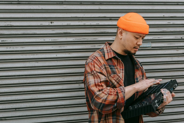 a man holding his hat and a camera