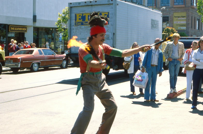 woman in street clothes with burning stick and hat