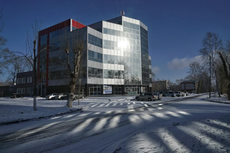 a large office building in front of a very long building