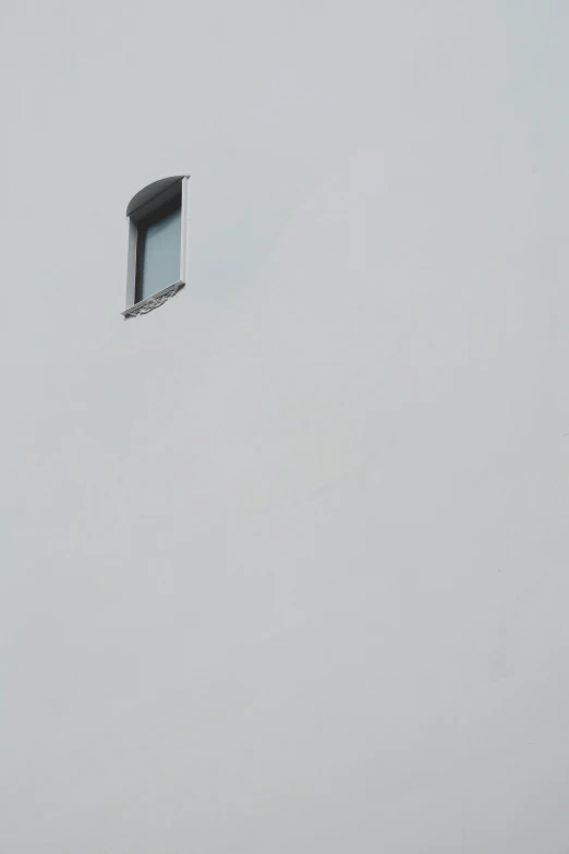 there is an open window in the side of a building