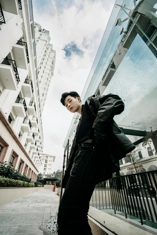 a man is leaning against the glass wall