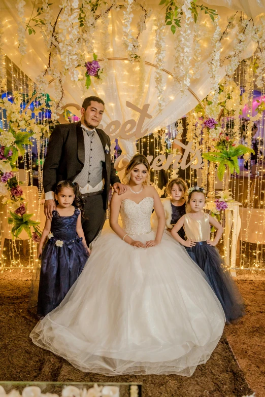 a man and woman are standing next to children