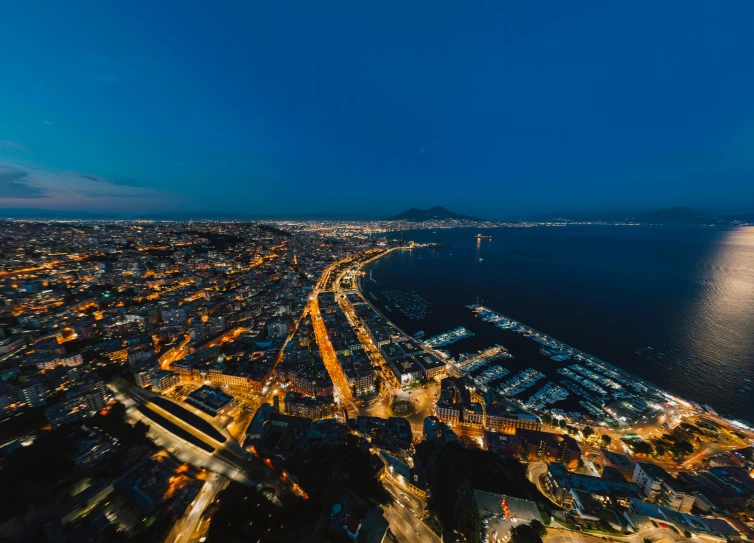 an aerial view of a street and the ocean